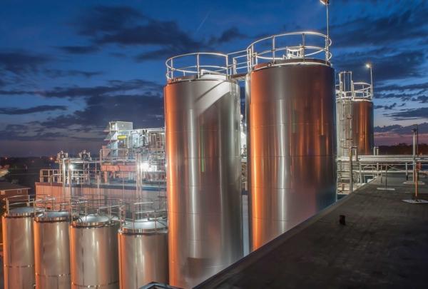 Dairy storage tanks at dusk.